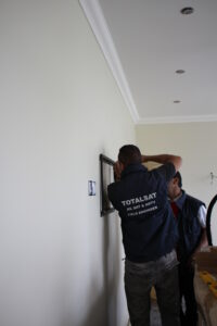 engineer fitting tv on wall